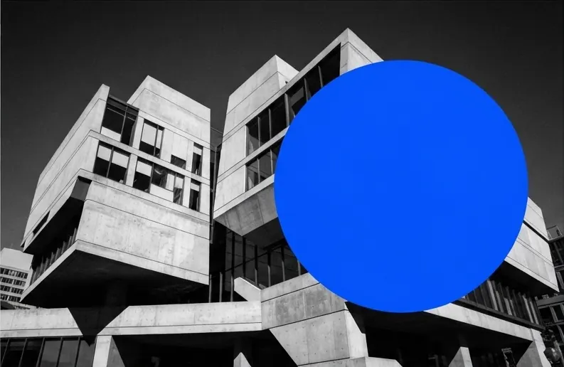 High-contrast concrete architecture in the Seaport overlaid with a flat blue circle